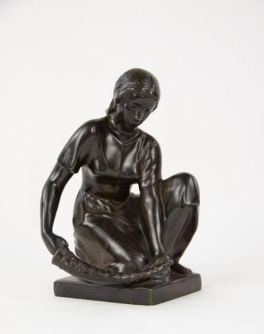 Just Andersen (Danish, 1884-1943): Disko metal sculpture of a woman kneeling and holding a large horn in her hands, back edge marked with "JUST" in a triangle and model number "D2164" and signed "Asta Lilbak (?)", base marked with "JUS