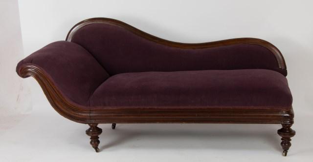 19th Century Victorian Chaise Lounge: Walnut frame with mauve upholstery, rising on turned legs terminating in casters; 70"L, 33"H, seat 18"H; good condition overall, repair to front corner