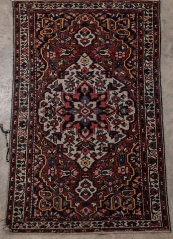 Persian Area Rug, 4'1" x 6'7": Central medallion and overall trailing floral design; 4'1"W x 6'7"L; overall moderate wear, small loss to one corner, wear and losses to binding on edges