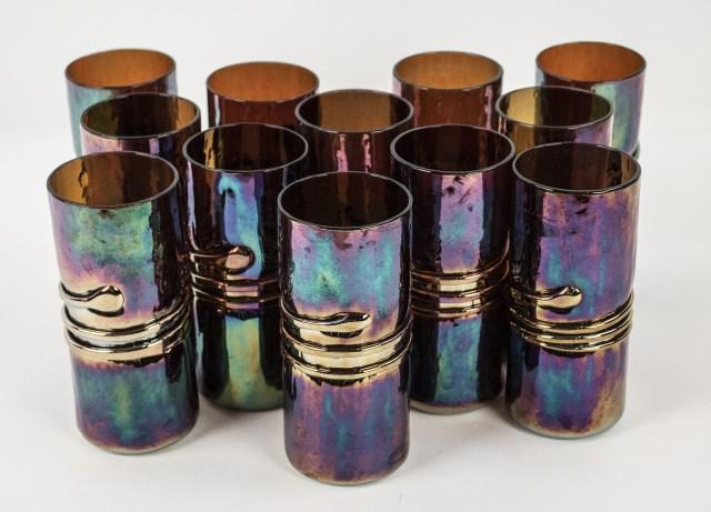 Set of 12 Esteban Prieto Glass Tumblers: Set of twelve handcrafted iridescent blue/purple glass tumblers, attributed to Esteban Prieto, each illegibly signed on base; approx. 5 3/4"H, 2 1/2" dia.; good condition (Ref. 79)