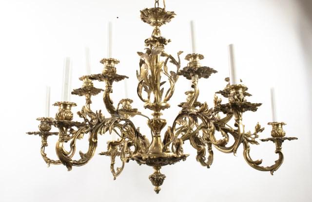 12-Light Foliate Motif Brass Chandelier: Six arms each supporting two lights, arms and column with foliate motif, matching ceiling plate, early to mid 20th century; 32"W, 22"H; has been rewired (Ref. 10)