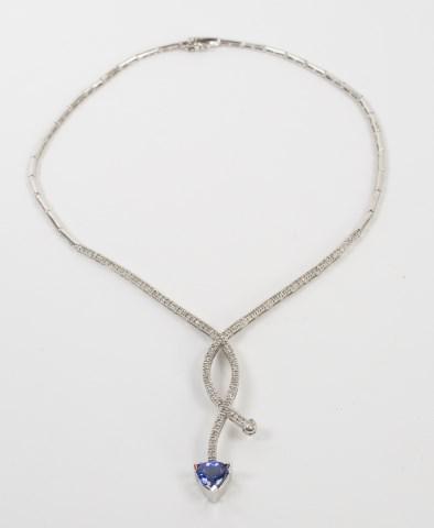 14kt White Gold, Tanzanite & Diamond Necklace: Tubular style links with a long cross-over pendant set with one hundred ten (110) natural round brilliant cut diamonds, 1.50 MM wide, total 1.65 carats, Color Grade H-I, Clarity Grade SI1-SI2; one cro