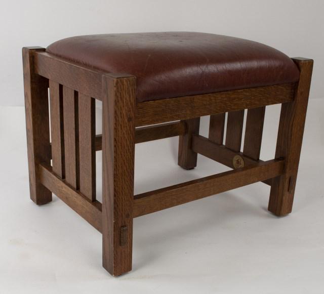 Stickley Audi Arts & Crafts Style Oak Footstool: No. 89-395, spindled sides and dark red leather seat, branded mark and metal tag; 15" x 19", 15"H; good condition with scratches to leather (Ref. 107)