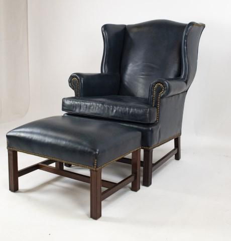 Hancock & Moore Leather Wing Chair & Ottoman: Chippendale style dark blue leather wing chair and ottoman, brass nailhead trim, molded legs with stretcher base, chair with loose cushion, each with label for Hancock & Moore; chair 31 1/2"W, 42"H, s