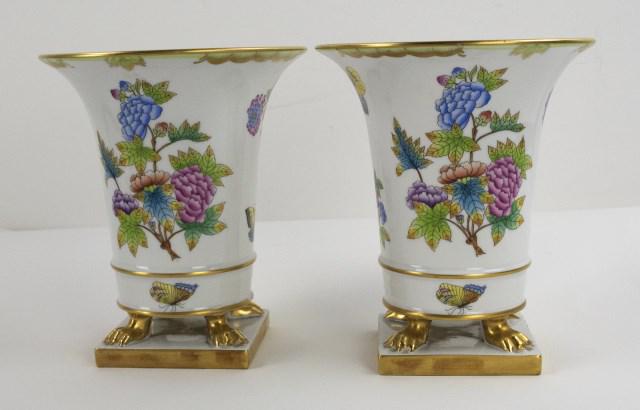 Pr. of Herend Porcelain Footed Vases: Pair of hand painted Herend vases in the Queen Victoria pattern with floral and butterfly decoration, raised on gilt paw feet, square plinth; 7"H, 6" dia.; one with chip to foot rim on side of vase (R