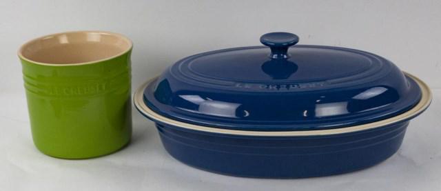 Large Le Creuset Stoneware Casserole & Jar: 1. Le Creuset blue oval stoneware casserole with lid; 17" x 13", 6 1/2"H---2. Le Creuset green cylindrical jar, 2.75 quarts; 6 3/4" dia., 6"H---both appear to be in unused condition (Ref. 33)