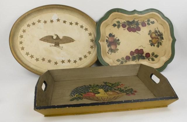 Three Vintage Painted Trays---Tole & Wood: 1. Oval tole tray decorated with an eagle with arrows in talons surrounded by stars; 25 1/2" x 20 1/2"; scratches with loss of paint---2. Shaped tole tray decorated with strawberries, pears and peache