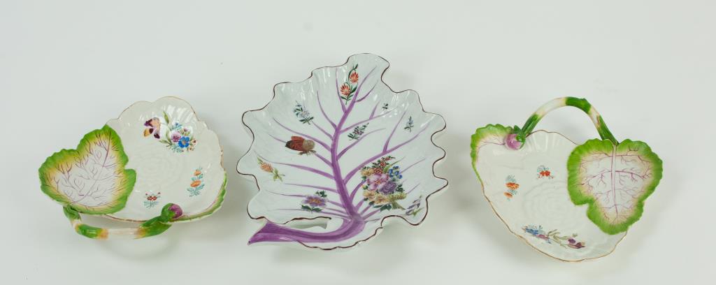 Three Mottahedeh Leaf Form Dishes: 1. Pair of Chelsea style leaf and lotus flower form dishes having a stem and bud handle, hand painted with leaf and flower details and floral sprigs, each marked on base "Italy" and with remnants of r