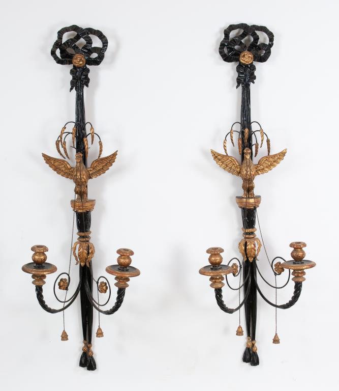 Pair of Large Italian Eagle Sconces: Early 20th century, pair of carved ebonized and gilt wood and metal candle wall sconces, Federal / Neoclassical style, tied bow pediment, a spread-winged eagle perched at center and having tassels han