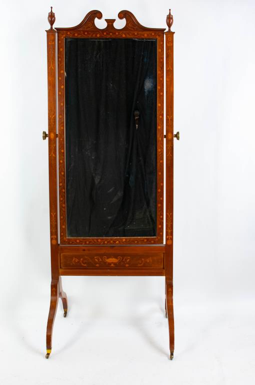 Neoclassical Style Inlaid Walnut Cheval Mirror: Late 19th century; mirror frame having a broken arch pediment and inlaid with rosettes, scrolls and a running floral vine; beveled mirror over skirt inlaid with urn and scrolls; square side posts havi