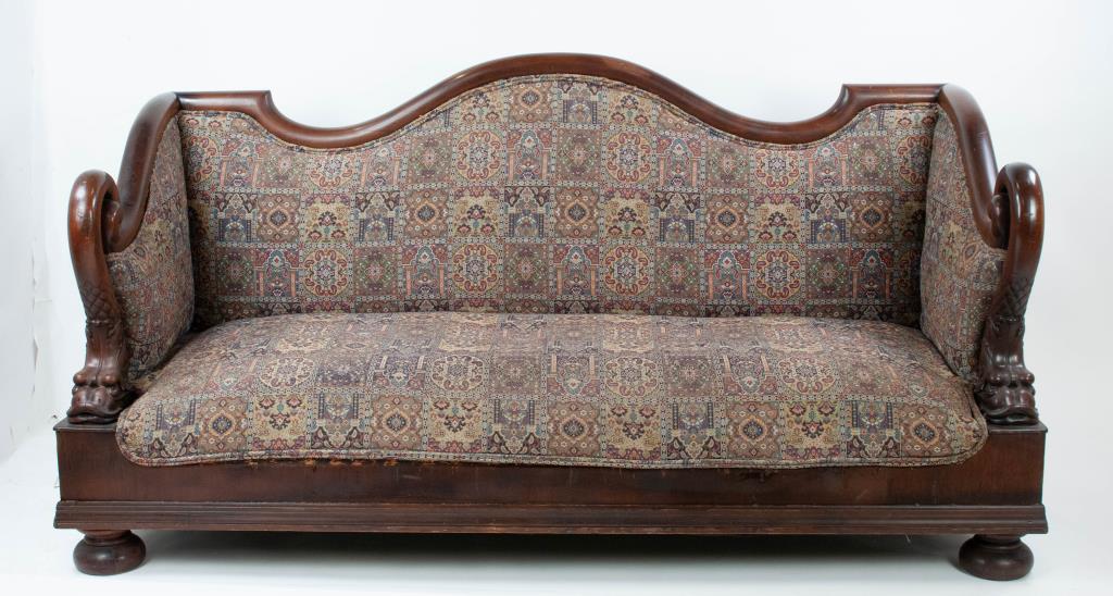American Empire Sofa w/ Dolphin Carved Arms: American mahogany Empire sofa, mid 19th century, shaped crest rail, serpentine arms terminating in boldly carved dolphins, bun feet, later upholstery; 79"W, 41 1/2"H, 30 3/4"D; small hole in upholster