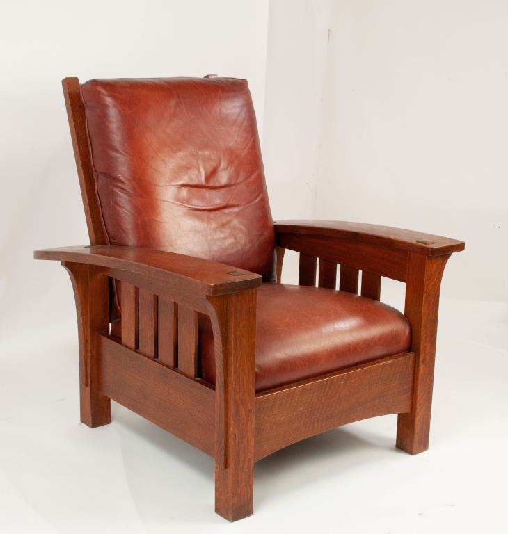 Stickley Audi Oak Bow Arm Morris Chair: Arts and Crafts style Morris chair, long bowed arms, slatted sides and back with four adjustments; tight seat cushion and loose back cushion upholstered in reddish/brown leather; branded mark and meta