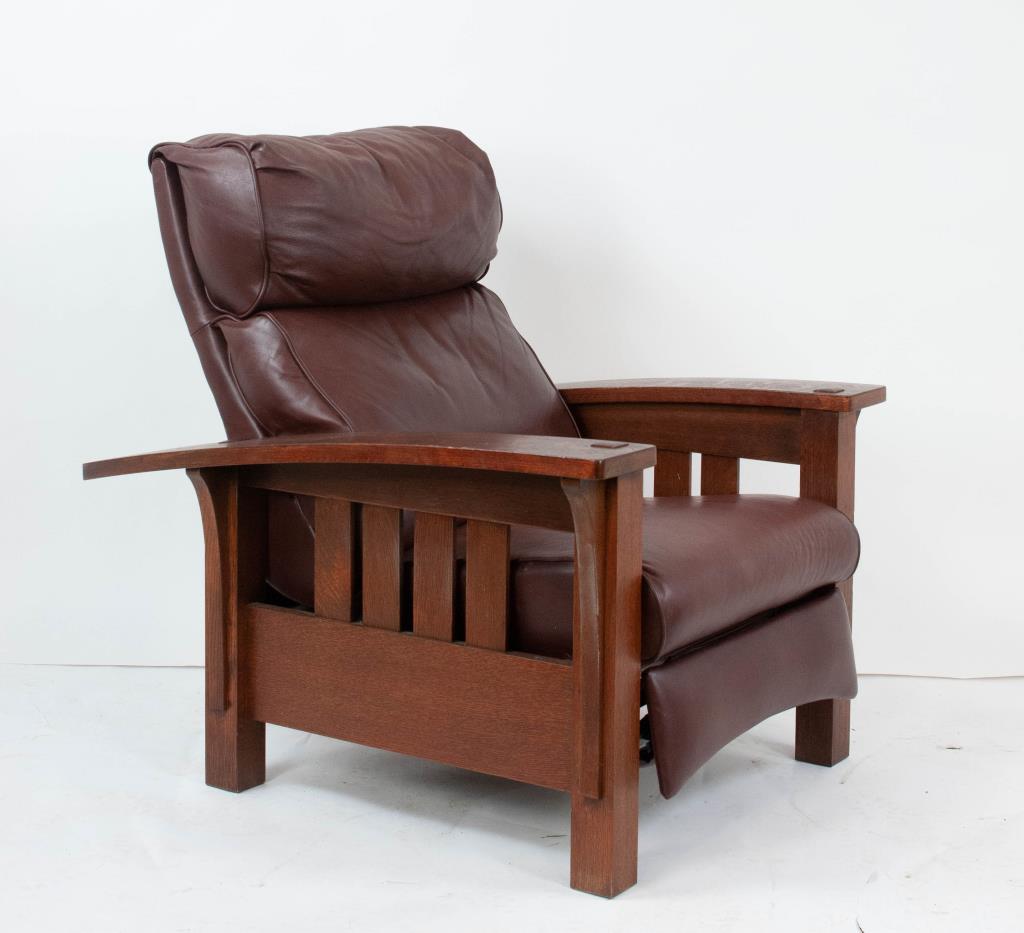 Stickley Audi Oak Bow Arm Morris Recliner: Arts and Crafts style recliner styled as a Morris chair with bow arms and slatted sides, brown leather upholstery, branded mark and metal tag, stamped "89-406 32"; approx. 35 1/2"W, 40 1/2"H, 42"D upr