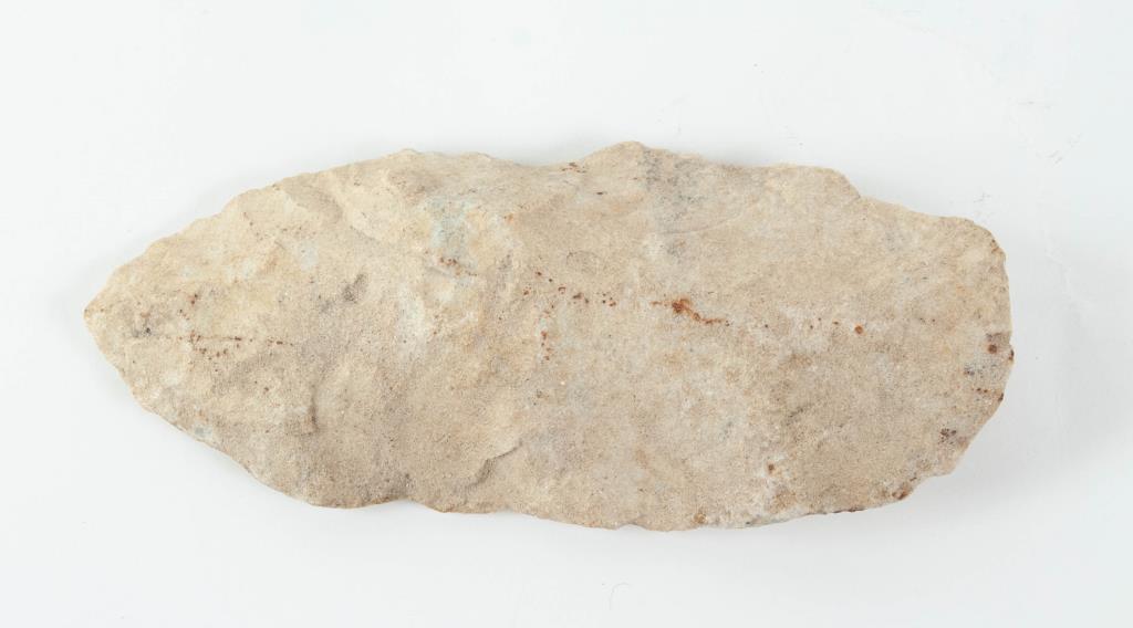 Homo Habilis Stone Hand Axe 1.8 Million Years Old: Archaic human stone hand axe, 1.8 million years old, with Certificate of Authenticity from Sadigh Gallery Ancient Art, New York; 6 1/4"L, 2 3/4"W