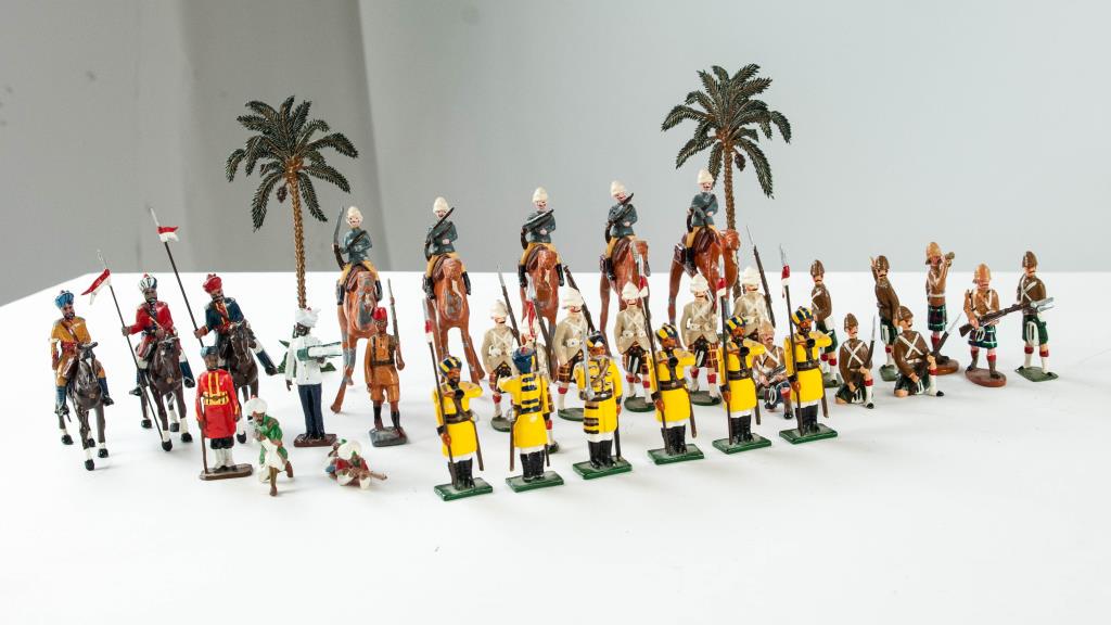 35 Indian & British Toy Lead Soldiers, Palm Trees: Three on horseback, unmarked; Five on camels, unmarked; Six Marlborough Indian Army soldiers, each marked "MMM / Made in UK"; One John Tunstill; One with paper label "British Bulldog Series / Made in 