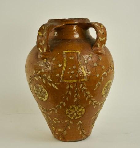 French Raised Floral Glaze Earthenware Jar: Ovoid with double handles placed on front of jar, floral and pinwheel designs to front; 13"H; scattered surface and glaze chips, chips to edges of handles and rims