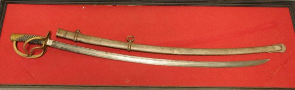 U.S. Model 1860 Light Cavalry Sword by Roby Marked : U.S. Model 1860 Light Cavalry Sword by Roby Marked "C. Roby, W. Chelmsford, Mass" on blade; dated US/1865/AGM; leather grip with wire; brass guard; metal scabbard; mounted on red felt in black painted