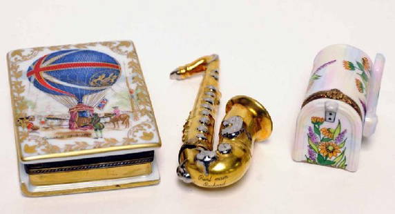 Three Painted Limoges Porcelain Boxes: 1, Book form with hot air balloon on cover and titled "Punardi 13-5-1785"; 2 1/2" x 3 1/4"; 2. Gilt saxophone; 4"; 3. Floral decorated mailbox; 1 1/8" x 1 7/8", 1 7/8"H