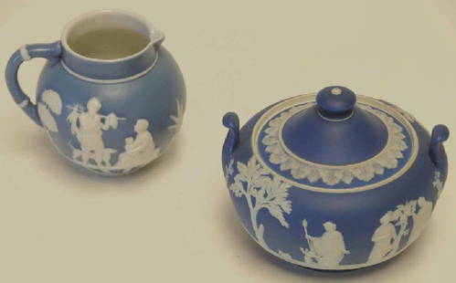 Wedgwood Med. Blue Sugar & Wedgwood Style Creamer: Covered sugar with classical decoration in white relief on blue field and having uplift tab handles; impressed mark; 4"H; repair to one handle; unmarked creamer with classical decoration in white