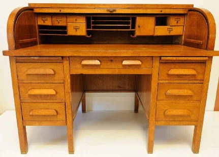 Oak Roll Top Twin Pedestal Desk: Fitted interior; base has central drawer flanked each side by pull-out writing surface and three drawers; 54"W, 44"H, 32"D