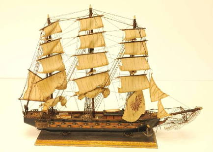 "Fragata Espanola" Wooden Ship Model: Three-masted ship with figurehead and 17 cannons on each side; main sail with painted double-headed eagle; two lifeboats, one resting on the rear starboard and one atop the cabin; anchors each 