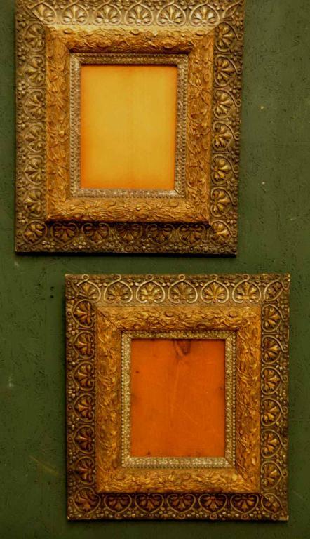 Pair of Aesthetic Movement Picture Frames: C. 1870; outer band decorated with a floral and anthemion pattern; inner band decorated with an ivy entwined tree limb; old glass and original backs; 18" x 20"; size of opening approximately 7 1/4" x 