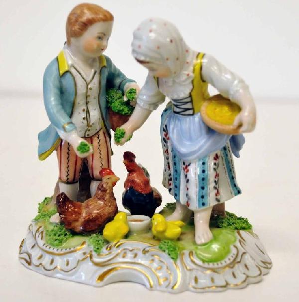 Carl Thieme, Dresden Potschappel, Porcelain: Figurine depicting a young boy and girl feeding chickens; marked with post-1901 blue underglaze Carl Thieme monogram and script "Dresden" and impressed "Y12291C"; 5 1/4"H, base approximately 5 1/4" x 