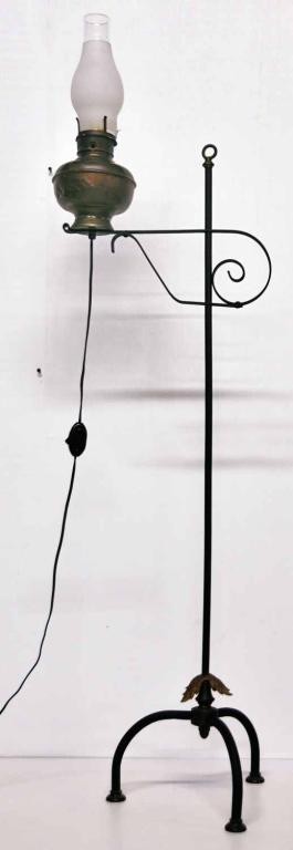 Miller's Vestal Kerosene Floor Lamp: Brass kerosene lamp electrified and mounted on wrought iron floor stand having an adjustable arm; lamp embossed "Miller's Vestal Made in U.S.A." for Edward Miller & Co. of Meriden, Connecticut; early 