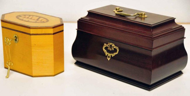 Two Tea Caddies--VMC Williamsburg Restoration +: 1. Virginia Metalcrafters Williamsburg Restoration tea caddy; mahogany with brass handle and escutcheon; marked on base; 6"H, 6" x 10"; key missing; 2. Octagonal tea caddy with light and dark wood ban