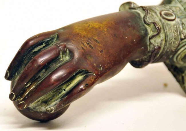 19th C. Brass Door Knocker: In the form of a lady's hand holding a small apple or ball, wearing a ring on middle finger, and having a ruffled sleeve with intricate decorations; approximately 5 3/4" in length
