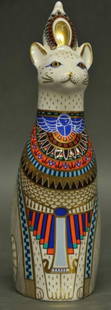 Royal Crown Derby 'Egyptian Royal Cat Figure': Egyptian' from the series 'Royal Cats'; cat sitting with robe and royal headdress; decorated in gold, blue, orange and brown; dated 1986; 8 1/2"H