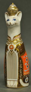 Royal Crown Derby 'Siamese Royal Cat Figure': Siamese' from the series 'Royal Cats'; cat sitting with robe and royal headdress; decorated in gold, blue, orange and brown; dated 1986; 8 1/2"H