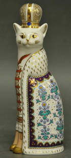 Royal Crown Derby 'Russian Royal Cat Figure': 'Russian' from the series 'Royal Cats'; cat sitting with robe and royal headdress; decorated in gold, blue, orange, purple and green; dated 1988; 8 1/4"H