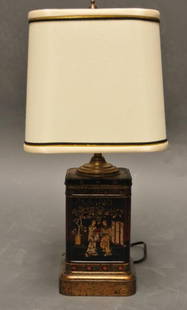Chinoiserie Style Tin Tea Canister Lamp: English black and gilt tin tea canister decorated with Oriental figures, now mounted as an accent lamp on a grained faux-bois base; 17"H to top of finial
