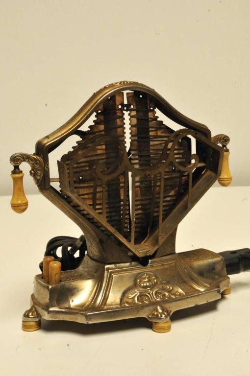 Universal E9410 Sweetheart Toaster: Art Deco style by Landers, Frary & Clark; c. 1929; original bakelite "earrings", push buttons, and feet; remarkable in its design to rotate bread completely around in order to toast both sides; good e