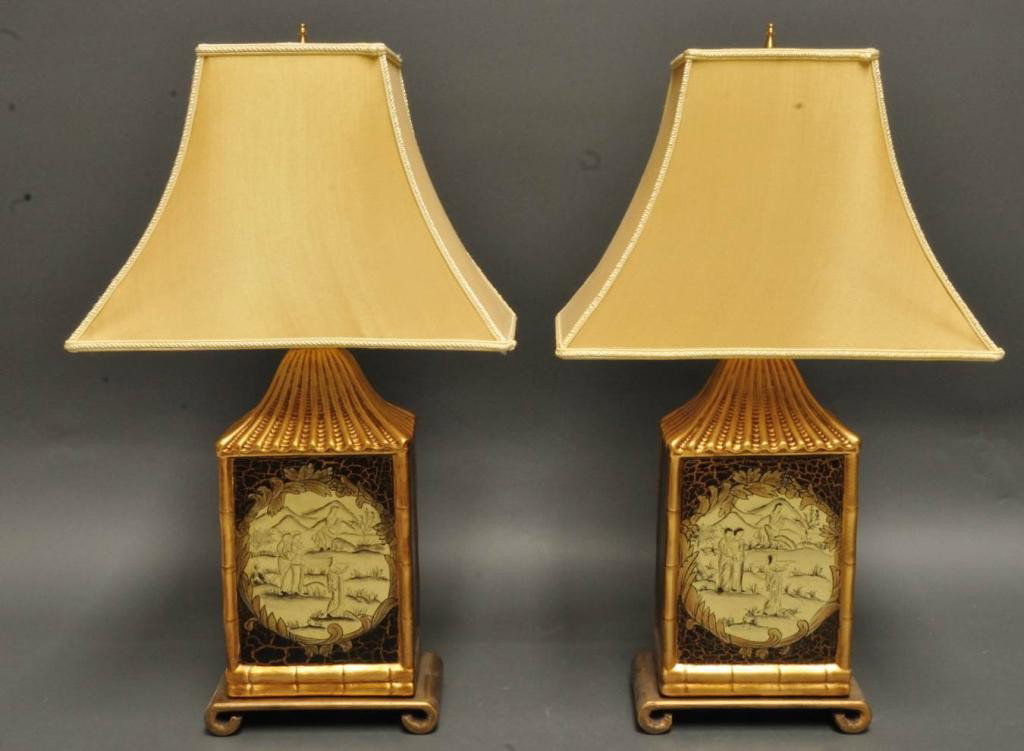 Pr. of Table Lamps with Chinoisserie Decoration: Black and gilt; decorated both sides with central medallions featuring Asian figures and landscapes; gilt faux bamboo trim; tops of lamps in shape of pagoda roof; with shades; second half 20th century