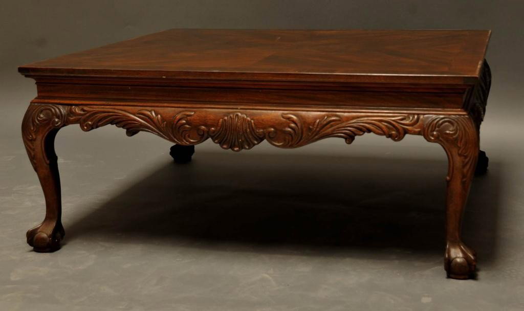 Chippendale Style Mahogany Coffee Table: Top banded and inlaid; carved frieze; ball and claw feet; 40" x 40", 18"H; talon missing on one foot, minor surface abrasions