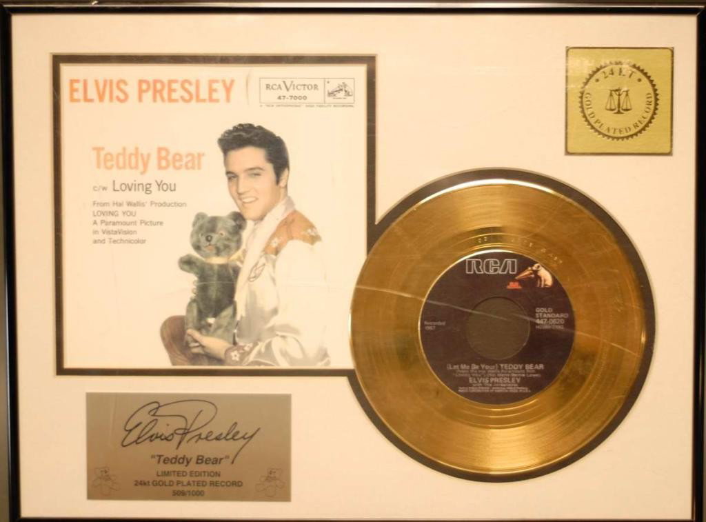 Elvis Presley "Teddy Bear" Limited Edition: Framed limited edition #509/1000 commemorative having 24kt. gold plated "Teddy Bear" 45 rpm record and sleeve; matted and under acrylic in black metal frame; 16 1/4"W, 12 1/4"H; scratches to acrylic