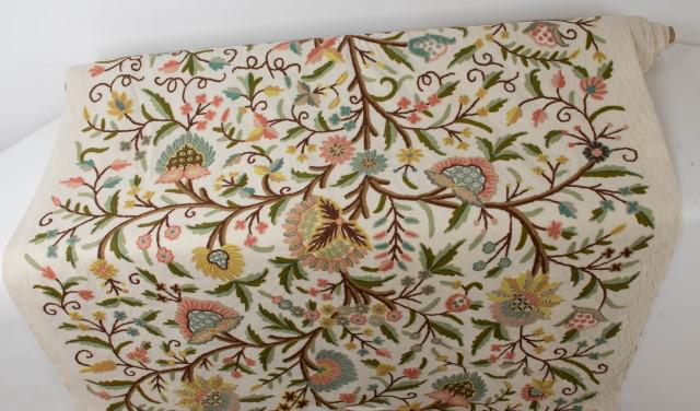 Roll of Crewel Embroidery Fabric: Overall multi-colored floral and foliate design, woolen yarns on cotton ground, approx. 51"W and just under 6 yards long; good unused fabric, possible small losses