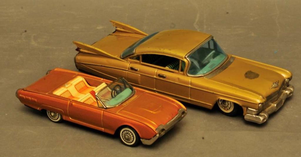 Bandai Cadillac and Ford Thunderbird: 1. 1959 Gold Cadillac sedan friction toy made by Bandai, Japan; tin litho; marked "Cadillac" on rear license plate; 11"L; surface scratches, small dents; one tail light missing, small crack to rear wi