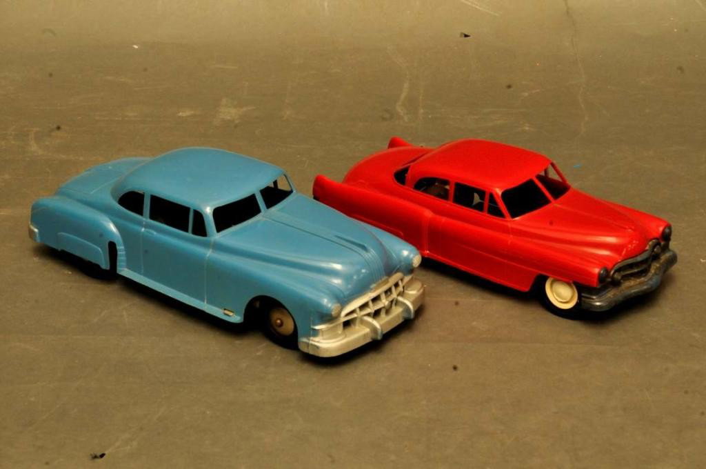 Marx Blue Pontiac, Red Cadillac: Two hard plastic friction cars, c. 1950s; Marx blue Pontiac, 10"L; red Cadillac with white walls, unmarked, 8 3/4"L