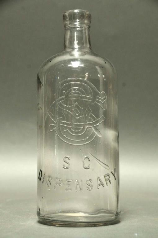 South Carolina Dispensary Quart Bottle No. 303: Clear cylindrical quart bottle No. 303 with monogram; "C.G. Co." embossed on base of obverse side, "130" embossed on bottom; #303 of "The South Carolina Dispensary A Bottle Collector's Atlas and Histo