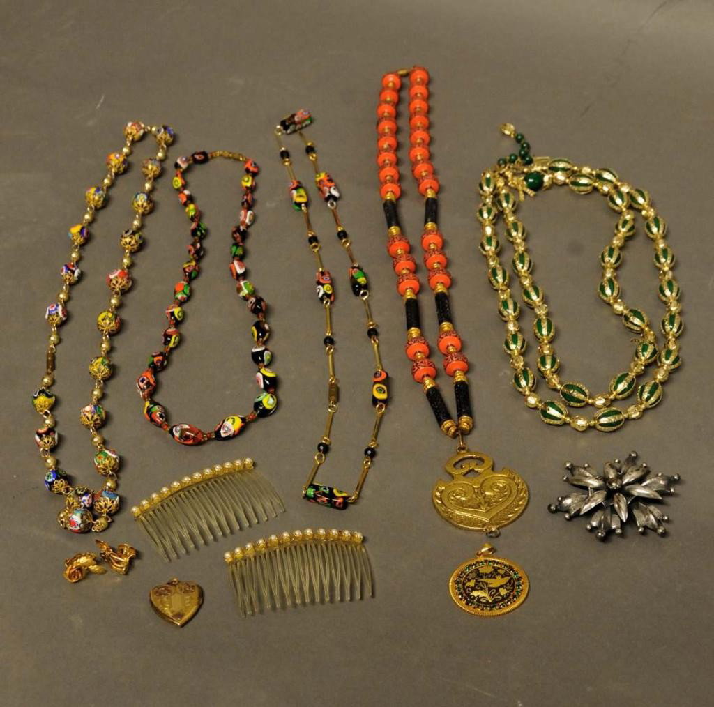 Collection of Jewelry, Inc. Glass Beads: Three glass bead necklaces, one with clasp broken; two other necklaces; heart-shaped locket; silvertone brooch marked "Accessocraft"; pendant; pair of rose shaped clip earrings; pair of hair combs wit