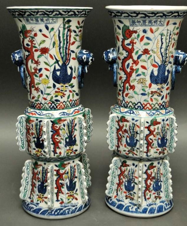 Pr. of Chinese Wucai Porcelain Vases: Three tier vase with lower two sections having dragons and phoenixes between six scalloped flanges, upper section with two handles and with dragons and phoenixes among flowering vines, all in shades o