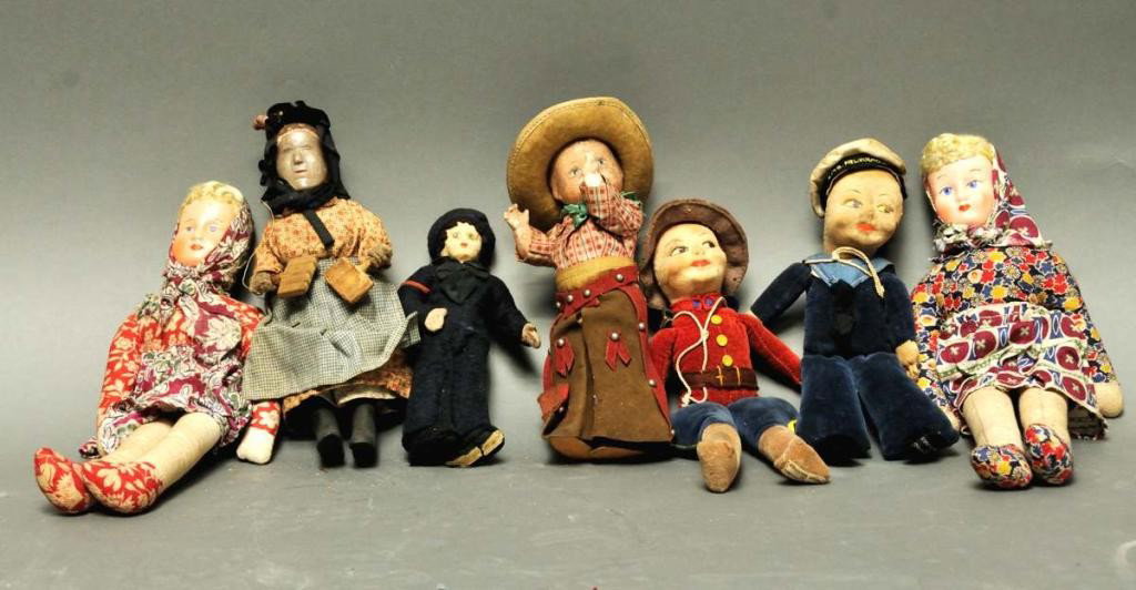 Seven Dolls--Norah Wellings, Effanbee, Etc.: 1. Norah Wellings "Mountie", 9 1/2"H, with tag; 2. Norah Wellings "Sailor", 8 1/2"H, with tag; 3. Two costumed female dolls with tags "Made in Poland"; 11"H; 4. Effanbee "Cowboy", 7 1/2"H, with tag; 5
