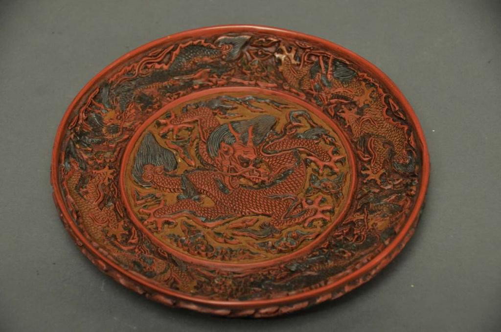 Signed Chinese Cinnabar Carved 'Dragon' Plate: Center, sides and exterior extensively carved with five-clawed dragons; artist signed on underside; 7 1/4" diameter