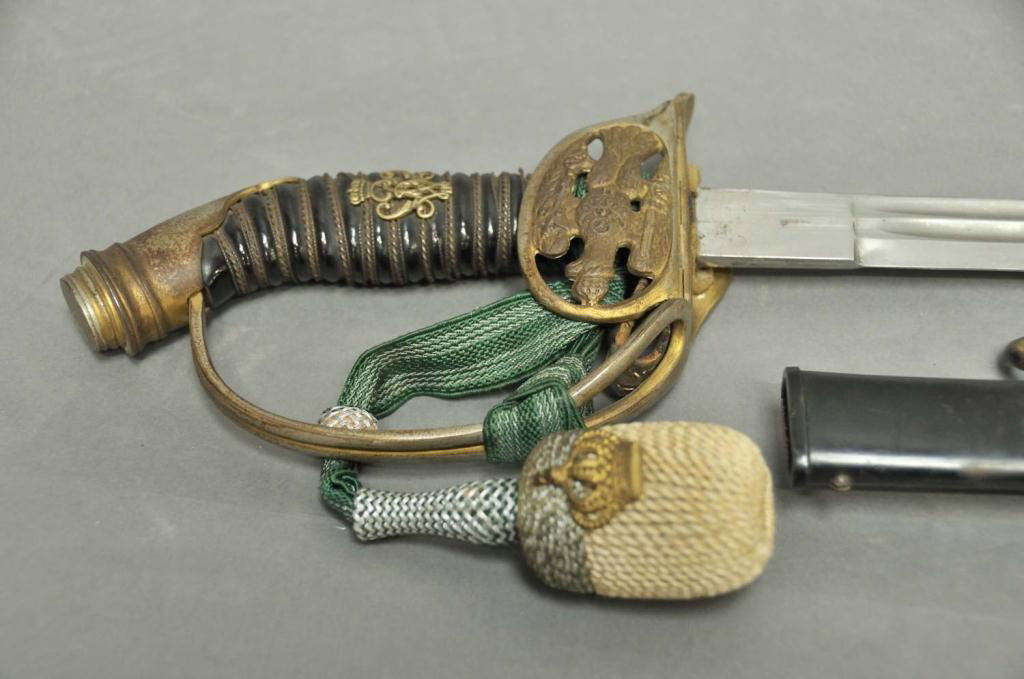 Imperial German Prussian M1889 Officer's Sword: 31" double fullered straight blade; folding/hinged guard pierced with Prussian Imperial eagle having cipher of Kaiser Wilhelm on breast; black celluloid grip with twisted gilt wire wrap, brass Wilhelm