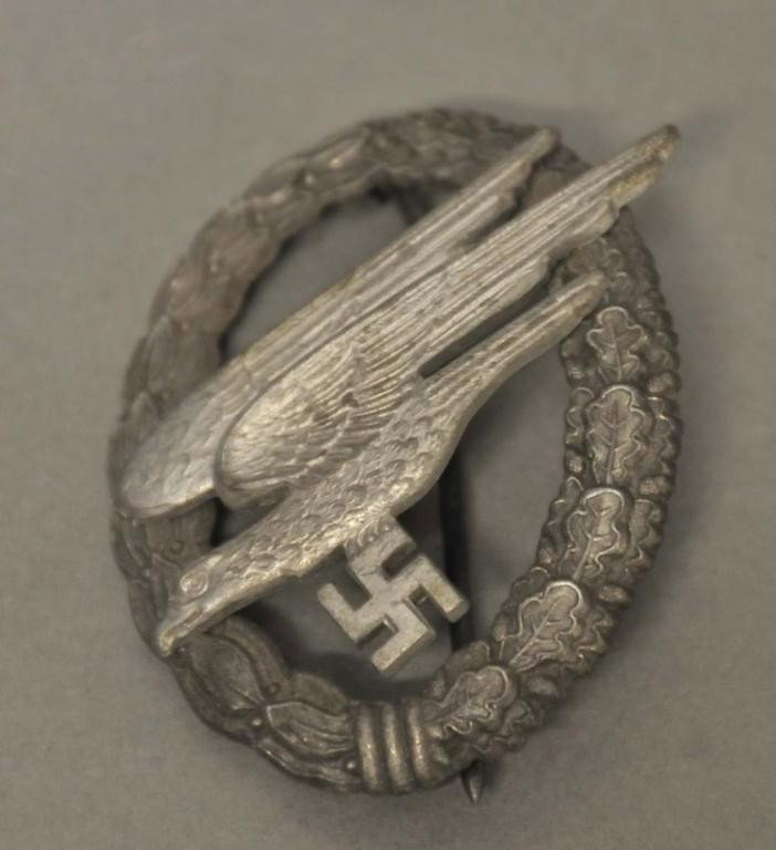 German Luftwaffe Nazi Paratrooper Badge: Diving eagle holding a swastika and surrounded by a laurel and oak leaf wreath; back with incised "A" indicating manufacture by F. W. Assman, Ludenscheid