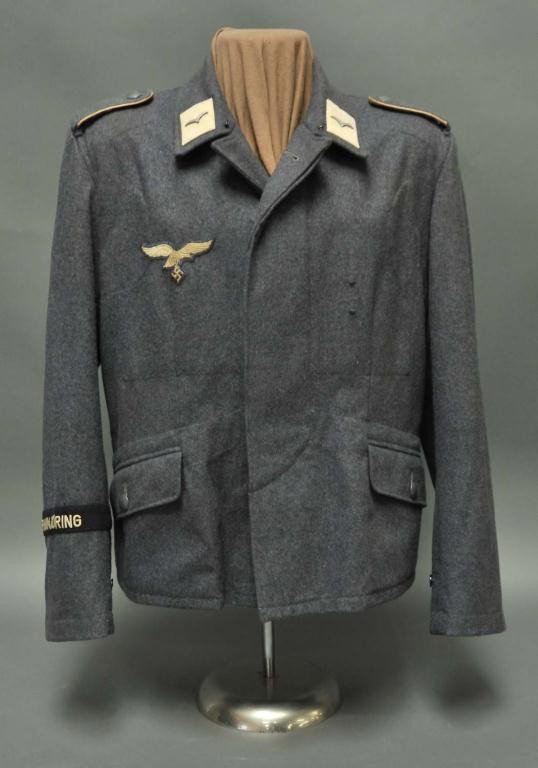 WWII Nazi Hermann Goring Division Flieger Tunic: Enlisted man's tunic on shirt form; made in 1944; size 45; blue gray wool retaining loops for badge; shoulder boards with white piping; Luftwaffe breast eagle; single gulls on collar tabs; small hole 