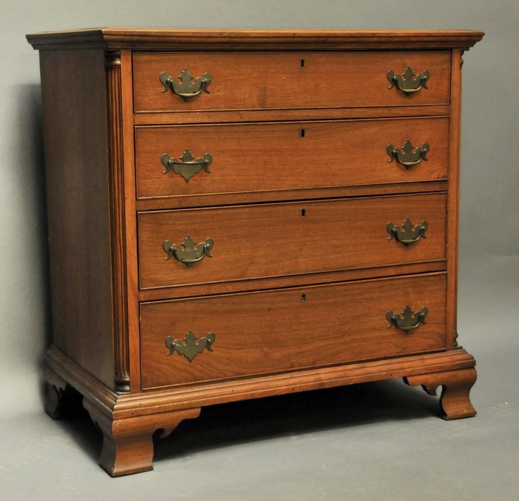 Chippendale Style Quarter Column Chest: Walnut with four graduated, cockbeaded and dovetailed long drawers; fluted quarter columns; ogee bracket feet; brass escutcheons; bench made early to mid 20th century; 33 3/4"W, 33 1/2"H, 19 3/4"D